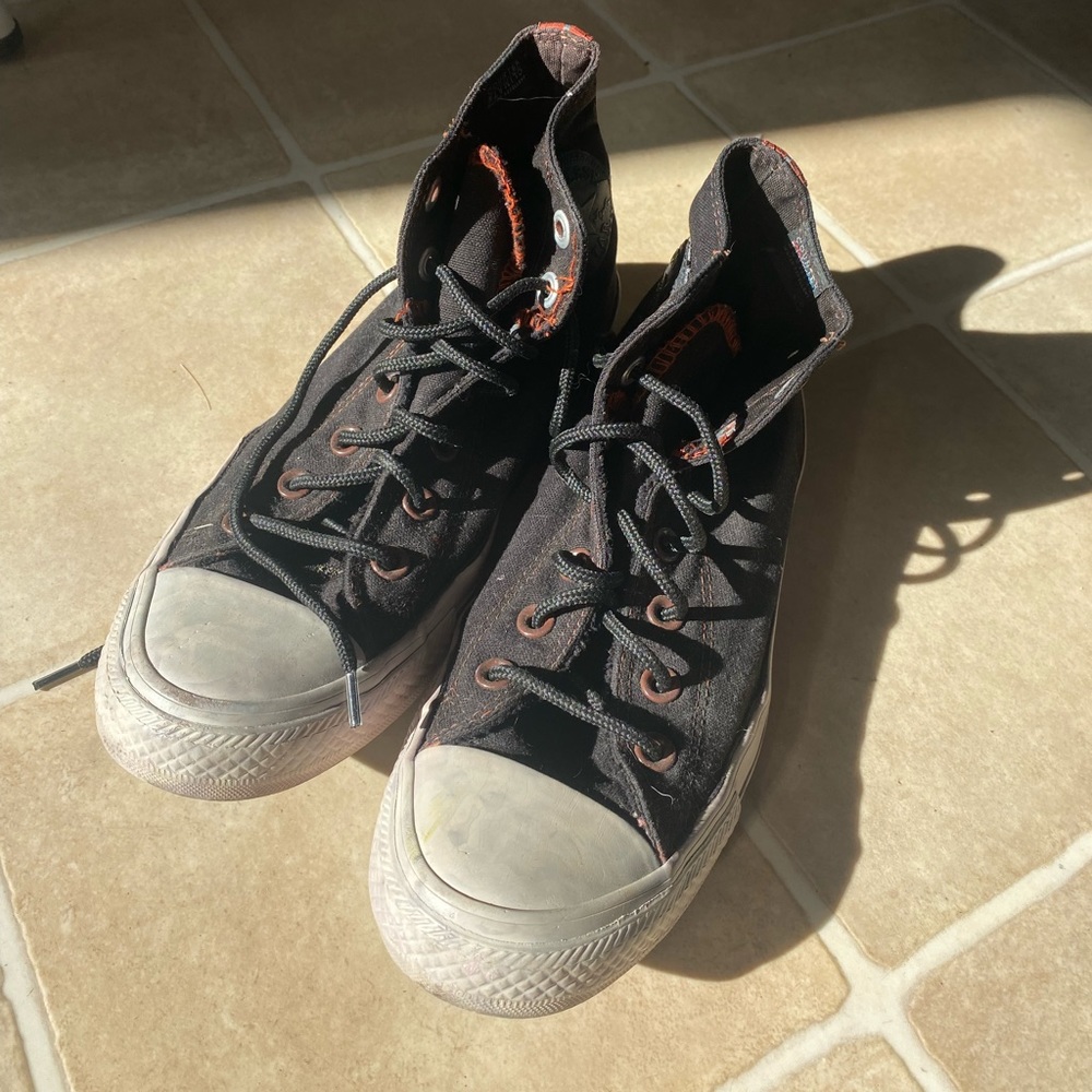 Black and red threaded converse high tops